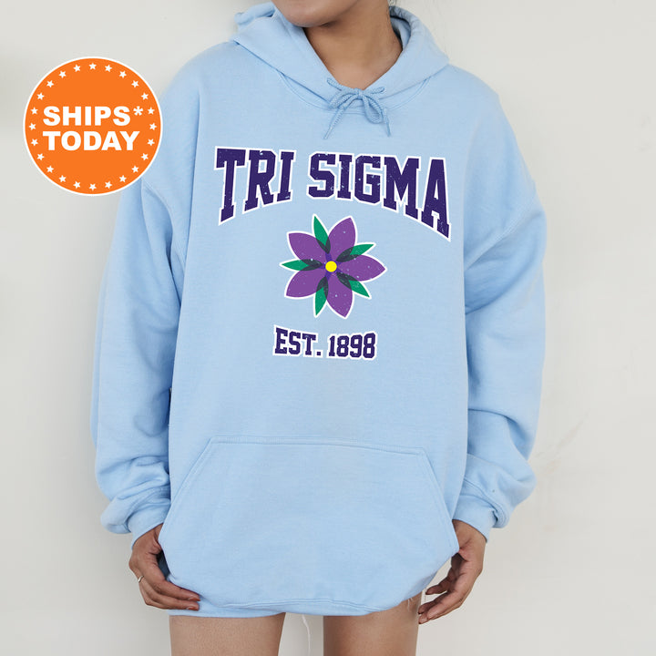 a woman wearing a blue hoodie with a flower on it