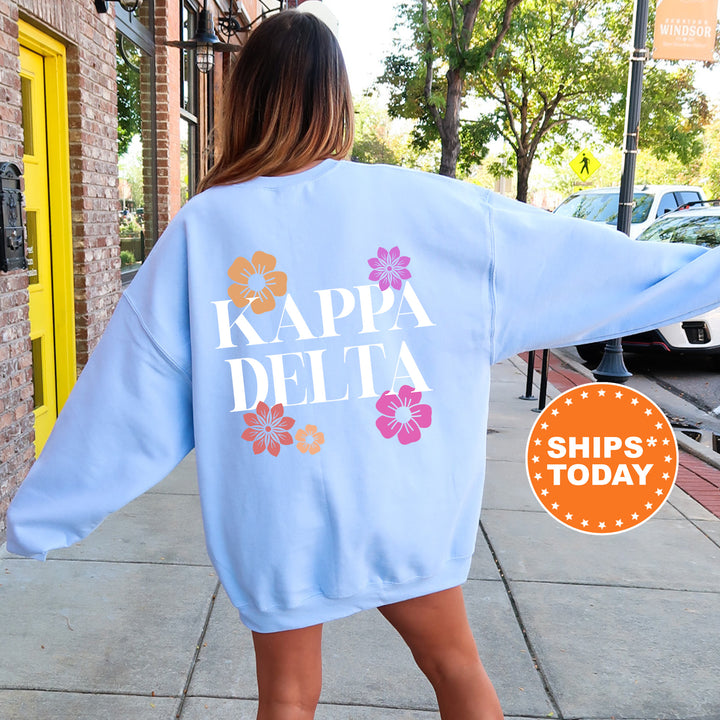 a woman walking down a sidewalk wearing a blue sweatshirt