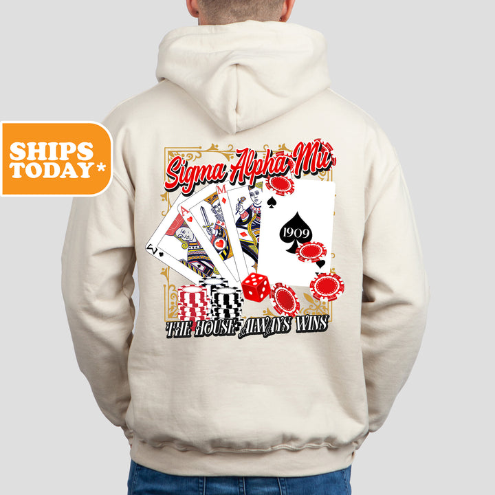 a man wearing a white hoodie with a picture of playing cards on it