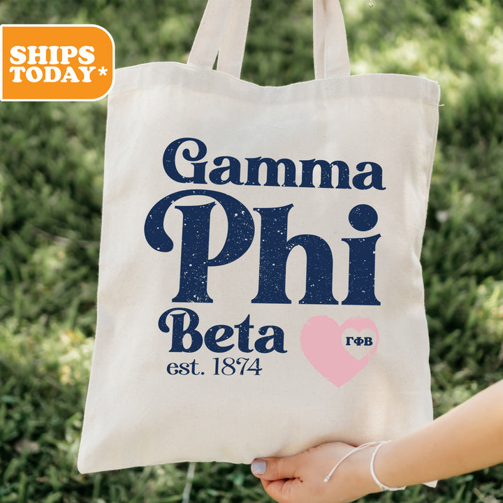 a person holding a bag with the words gamma phi beta on it