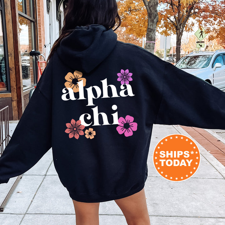 a woman wearing a black hoodie with flowers on it