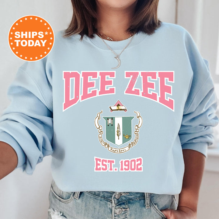 a woman wearing a blue sweatshirt with a crest on it