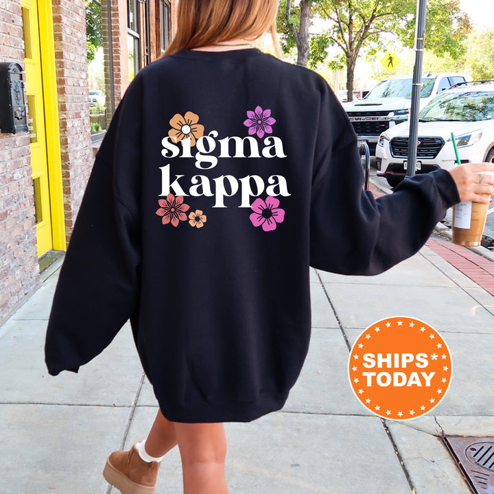 a woman walking down a sidewalk wearing a black sweatshirt