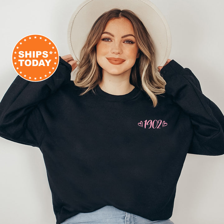 a woman wearing a black sweatshirt and a white hat