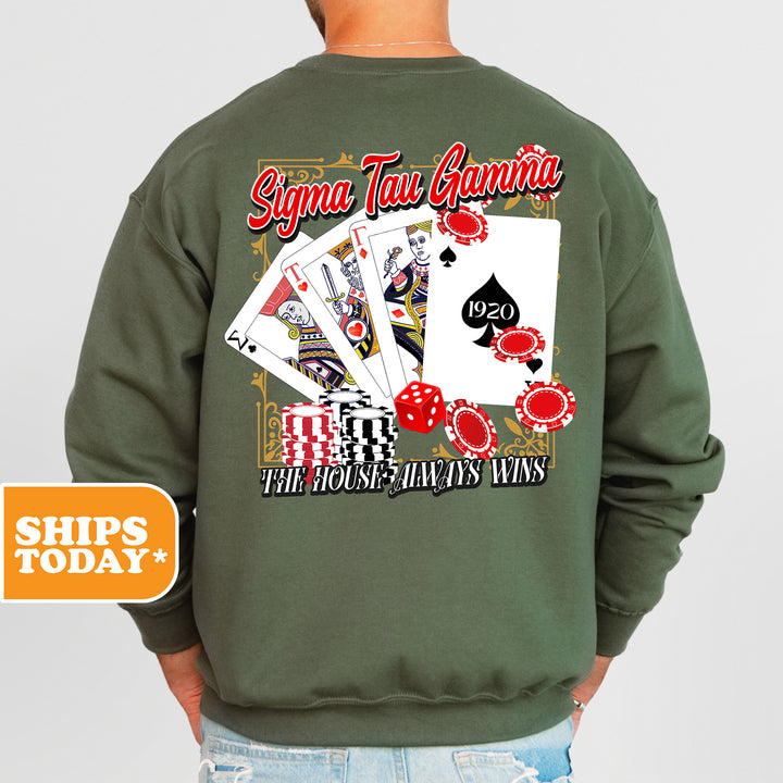 a man wearing a green sweatshirt with a picture of playing cards on it