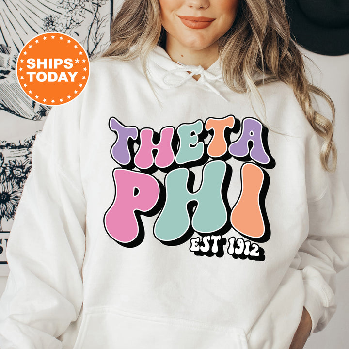 a woman wearing a white hoodie with the words delta phi est 1932 printed on