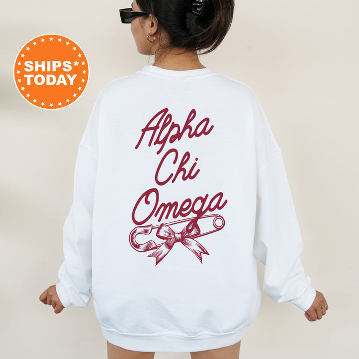 a woman wearing a white sweatshirt with the words ahha chi omega printed on it