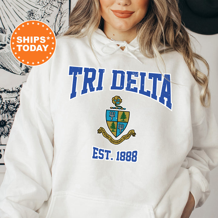 a woman wearing a white hoodie with the words tri delta on it