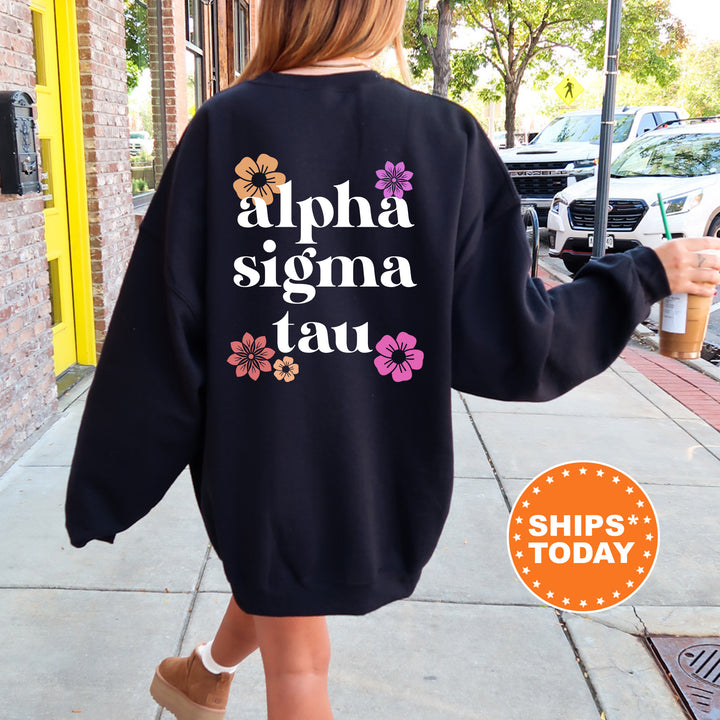 a woman walking down a sidewalk wearing a black sweatshirt