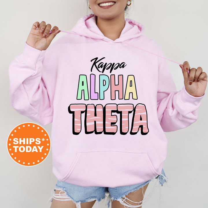 a woman wearing a pink hoodie that says, keep the alphabet thera
