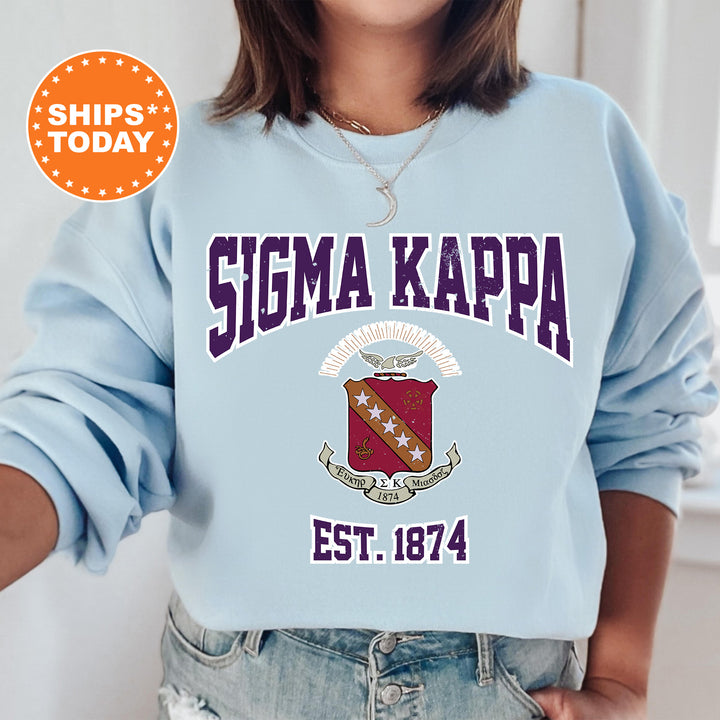 a woman wearing a blue sweatshirt with the slogan sigma kappa est