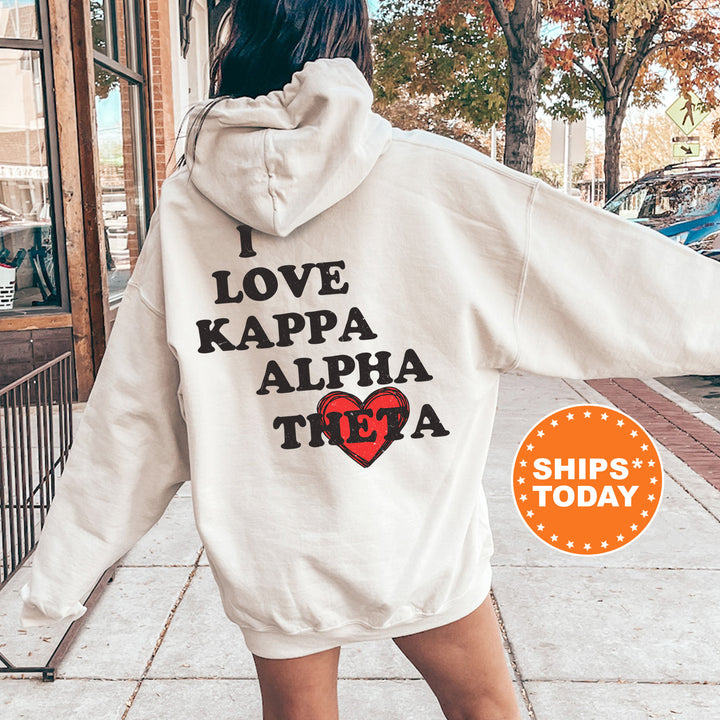a woman in a white hoodie that says i love kappa alpha