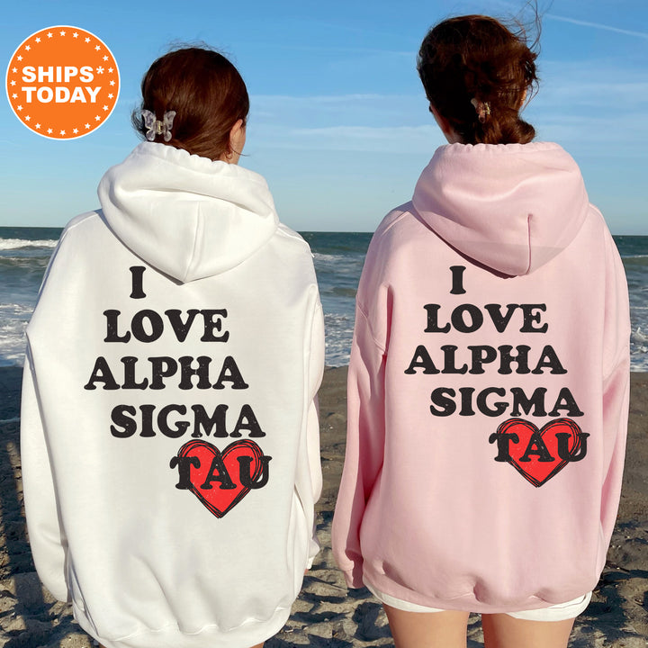 two women wearing matching sweatshirts on the beach