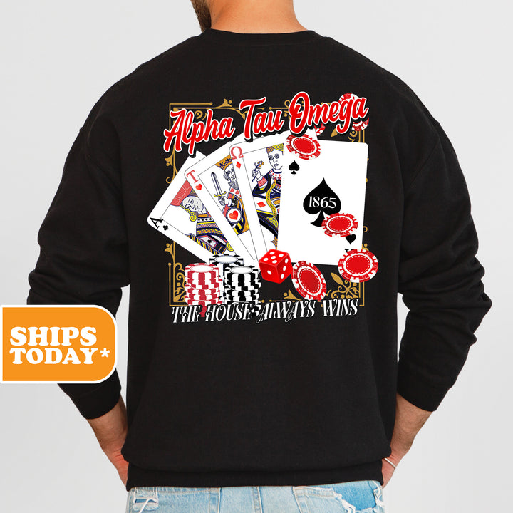 a man wearing a black sweatshirt with a picture of playing cards on it