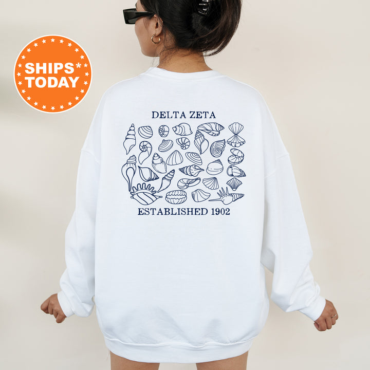 a woman wearing a white sweatshirt with a picture of different items on it