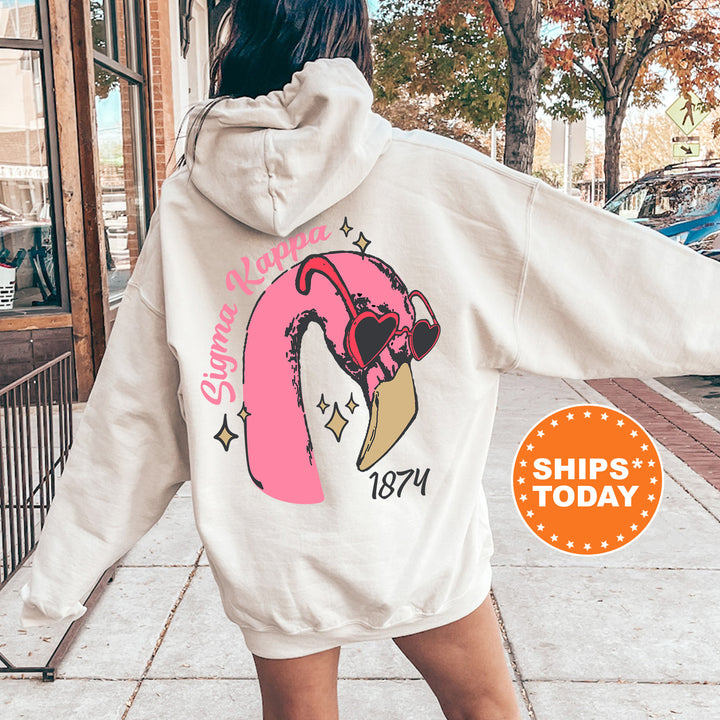 a woman walking down a sidewalk wearing a white hoodie