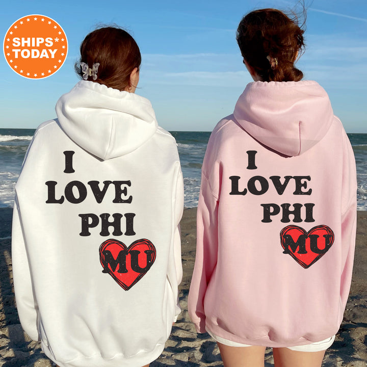 two women wearing matching sweatshirts on the beach