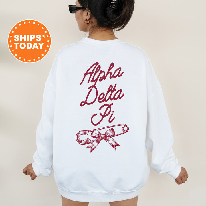 a woman wearing a white sweatshirt with the words aloh delta pi on it