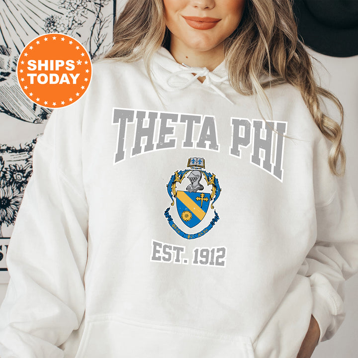 a woman wearing a white hoodie with a blue and yellow crest on it