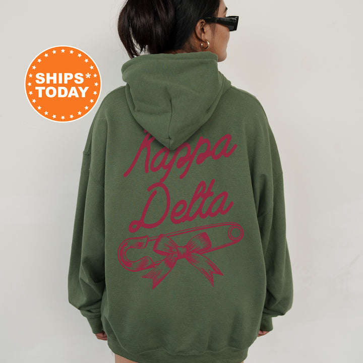a woman wearing a green hoodie with red writing on it