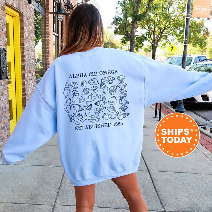 a woman walking down a sidewalk wearing a blue sweatshirt