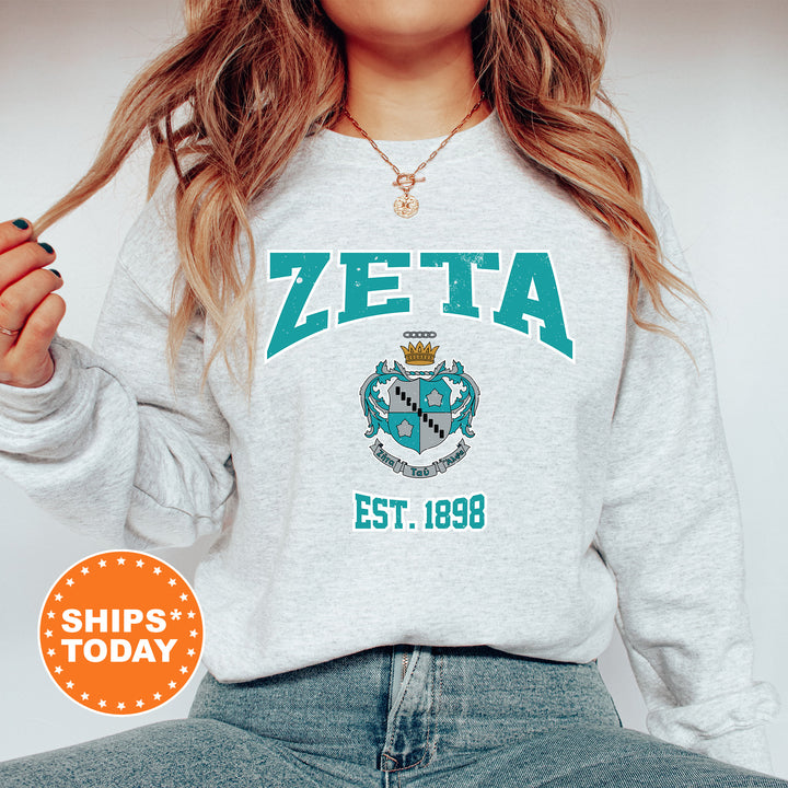a woman wearing a zeta sweatshirt and jeans