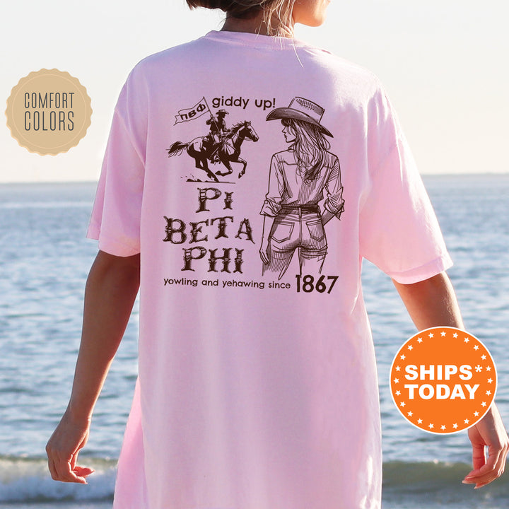 a woman wearing a pink t - shirt with a picture of a woman riding a