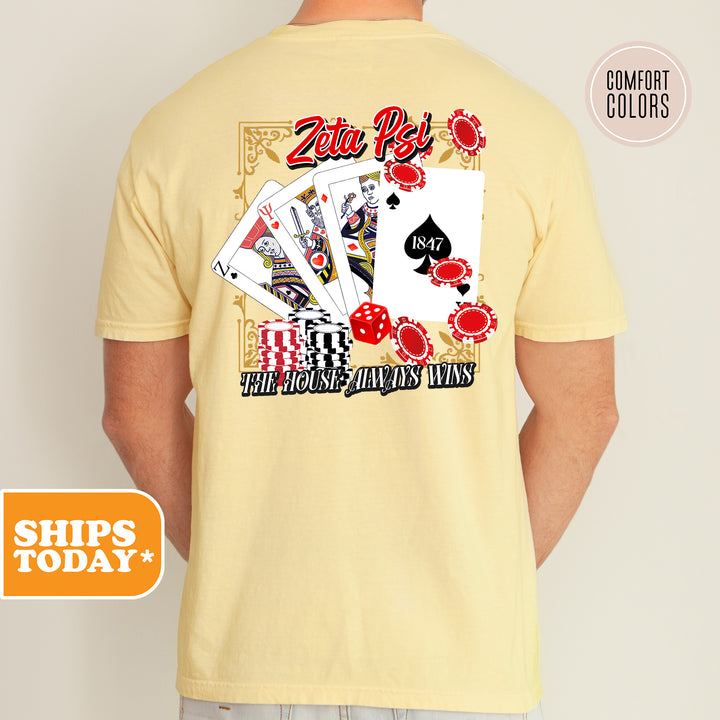 a man wearing a yellow shirt with a picture of playing cards on it