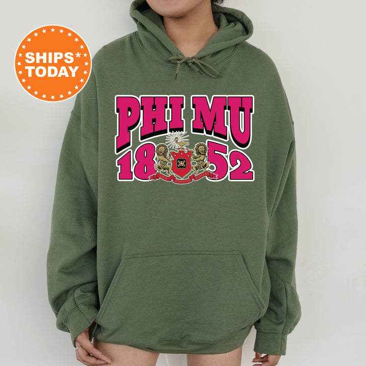 a person wearing a green hoodie with a pink and red design on it