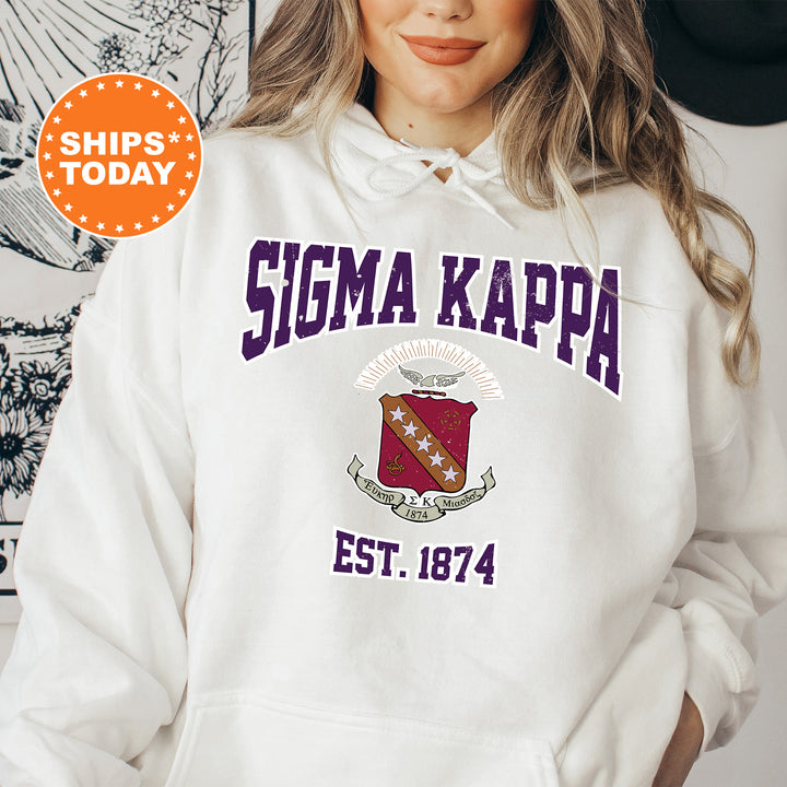 a woman wearing a white hoodie with the words stigma kappa on it