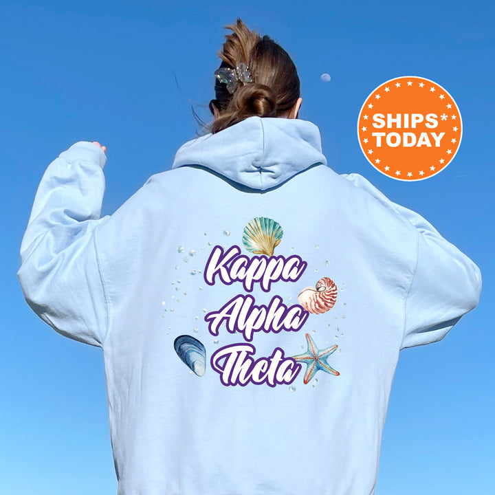 a woman with her back to the camera wearing a white hoodie that says ka