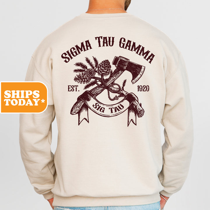 a man wearing a sweatshirt with a hammer and pine cones on it