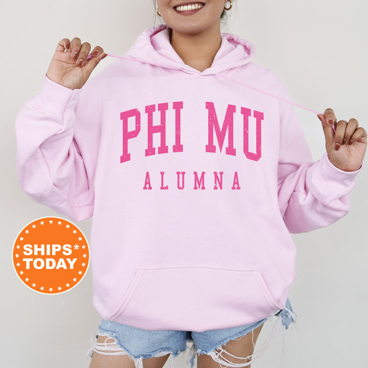 a woman wearing a pink hoodie and ripped shorts