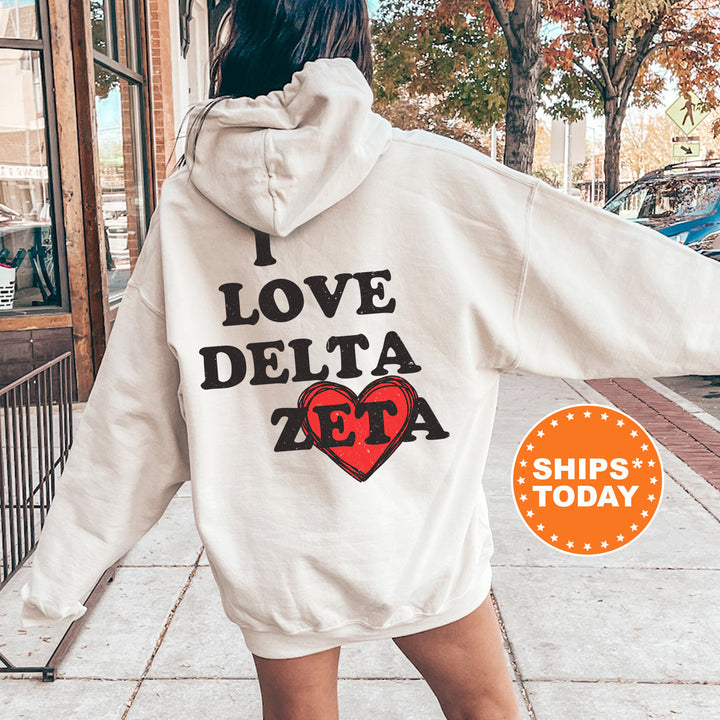 a woman in a white hoodie that says i love delta