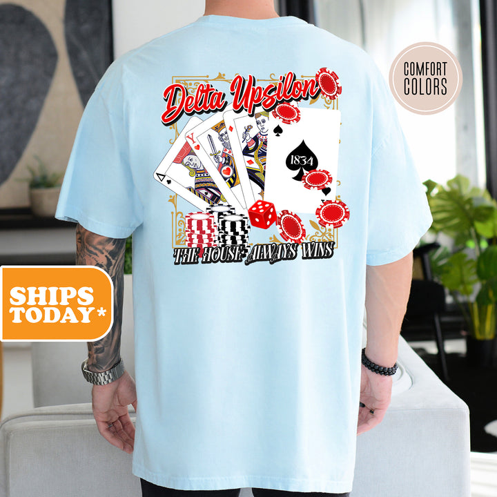 a man wearing a blue shirt with a picture of playing cards on it