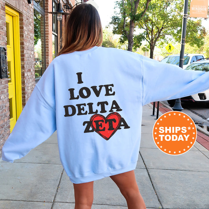 a woman walking down a sidewalk wearing a blue sweatshirt