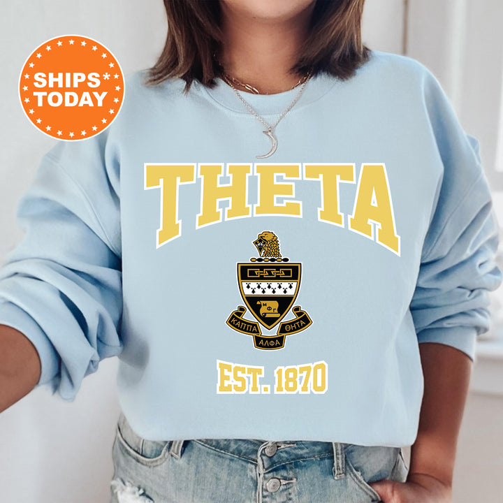 a woman wearing a blue sweatshirt with the words theta on it