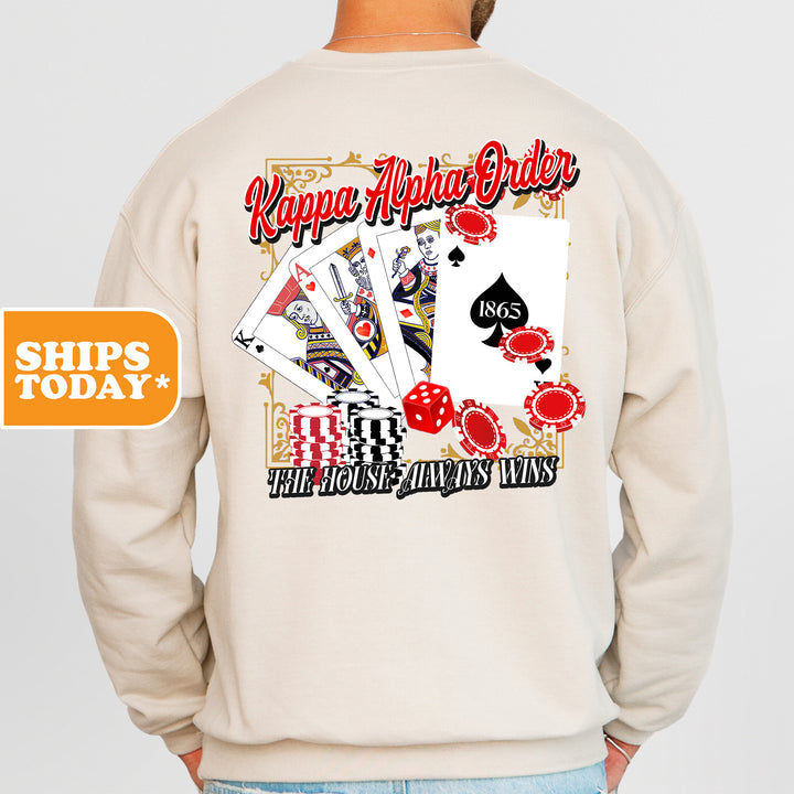 a man wearing a sweatshirt with a picture of playing cards on it