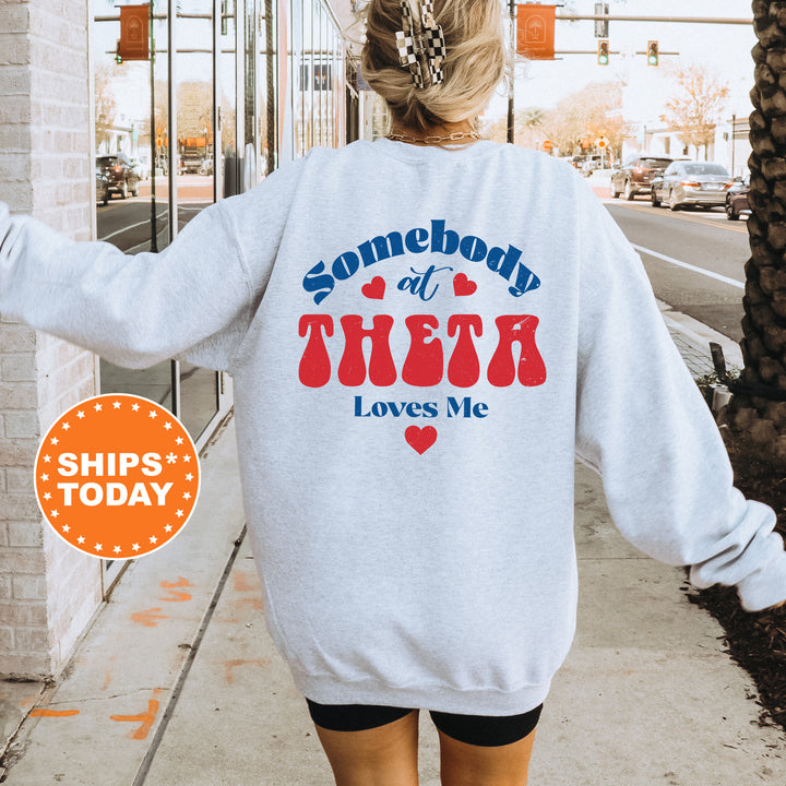 a woman walking down a sidewalk wearing a sweatshirt