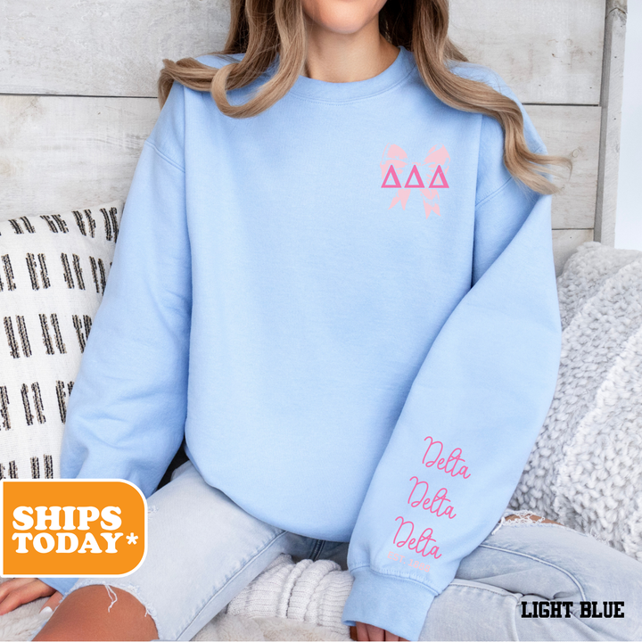 a woman sitting on a bed wearing a blue sweatshirt