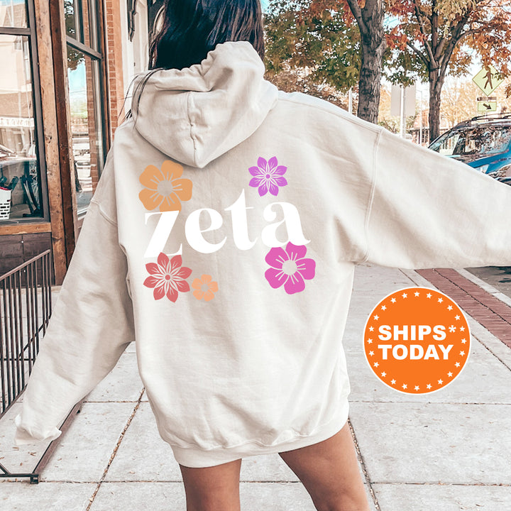 a woman walking down a sidewalk wearing a white sweatshirt