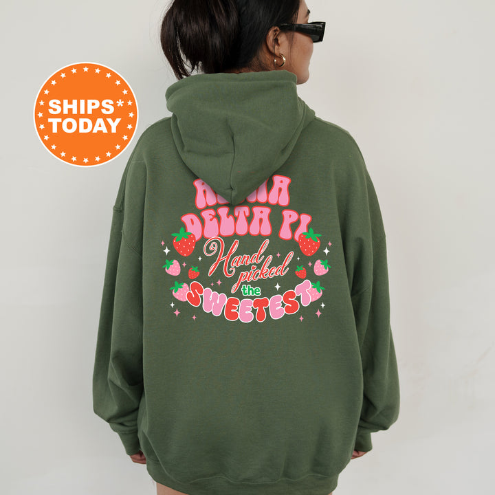 a woman wearing a green hoodie with pink writing on it