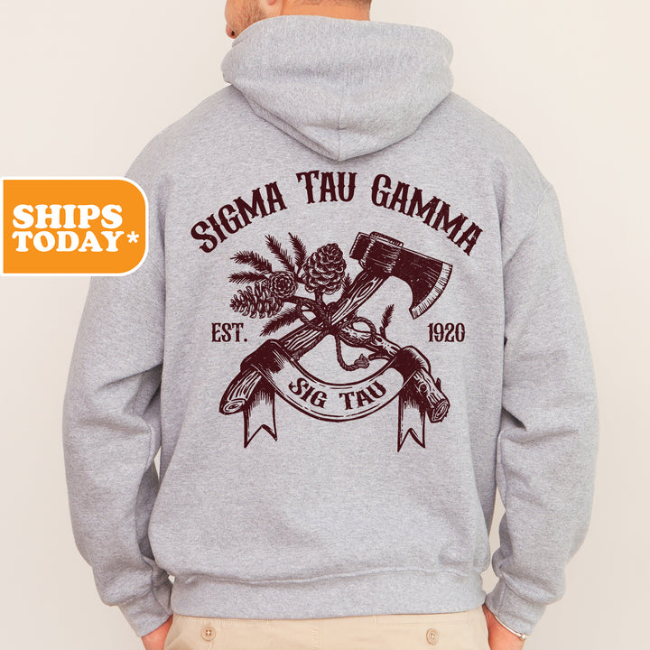 a man wearing a gray hoodie with an image of a hammer and a pine