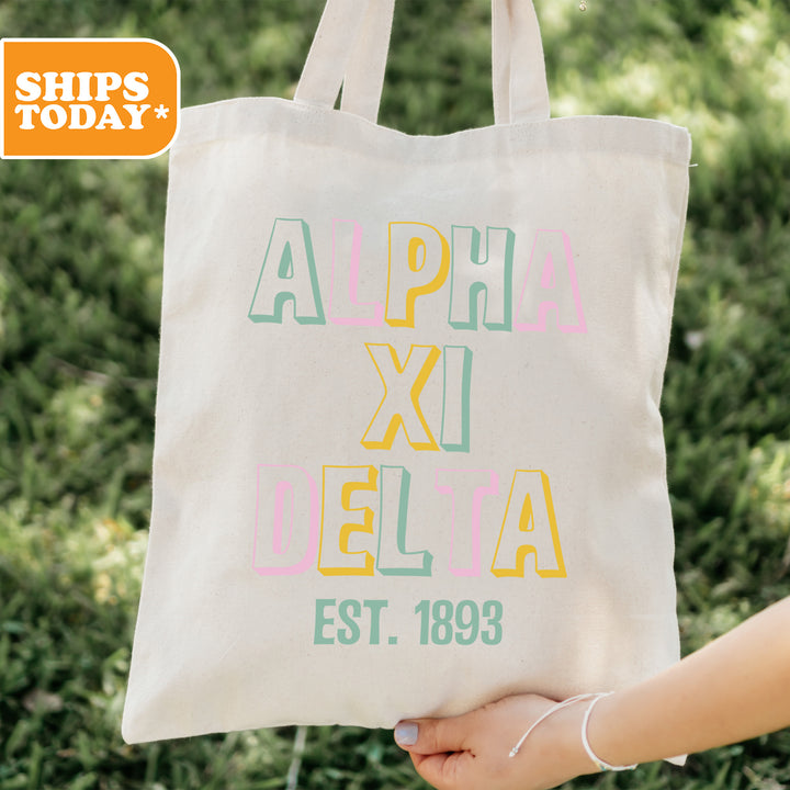 a person holding a tote bag in their hand