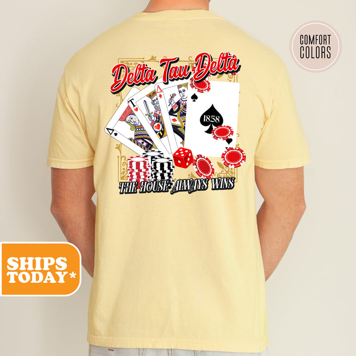 a man wearing a yellow shirt with a picture of playing cards on it