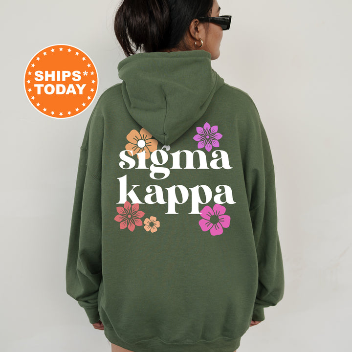 a woman wearing a green hoodie that says stigmaa kappa
