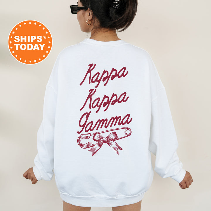a woman wearing a white sweatshirt with the words kapa kapa gamma on