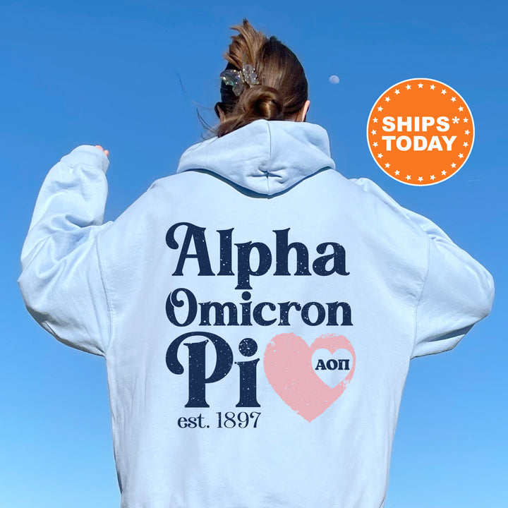 a woman wearing a white hoodie with the words alpha ommicron pi