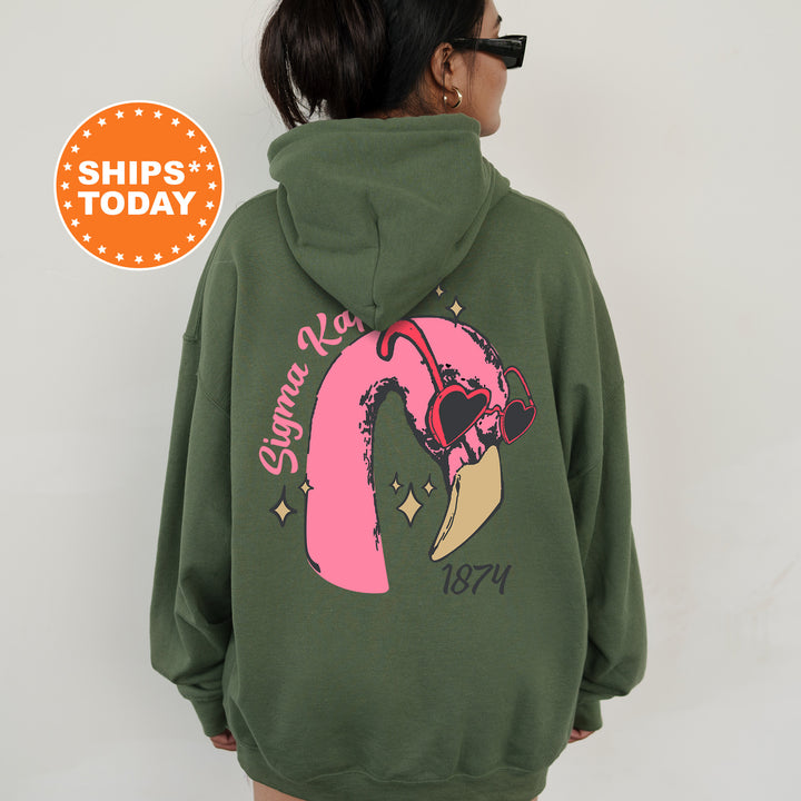 a woman wearing a green hoodie with a pink pony on it