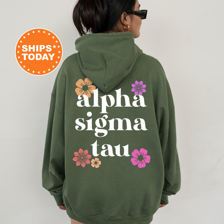 a woman wearing a green hoodie with flowers on it
